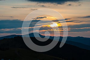 Carpathian mountains at sunset. Evening sky with clouds. Contrasting mountain landscape