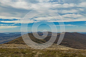 Carpathian Mountains top view landscape ridge autumn season dramatic weather time with cloudy blue sky background