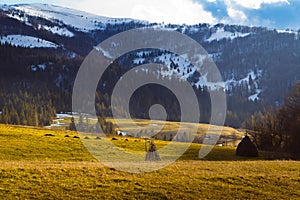 Carpathian Mountains in Transcarpathia, late evening sun in valley beneath peak of Gemba mountain, covered with snow, early spring