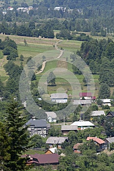 Carpathian village: country houses, gardens, forest and mountains. Lugi village Ukraine