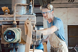 Carpenter adjusting the machine planer