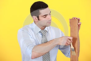 Carpenter applying varnish