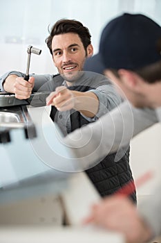 carpenter and apprentice installing luxury fitted kitchen