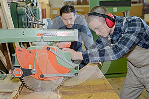 Carpenter with apprentice in training period