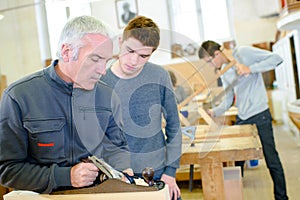 Carpenter with apprentice in training period
