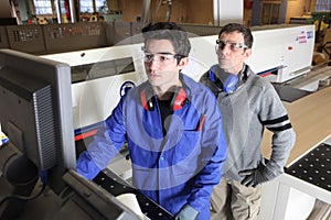 Carpenter and apprentice in workshop