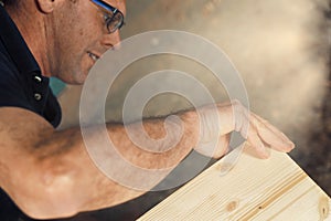 Carpenter assembles handmade furniture with care