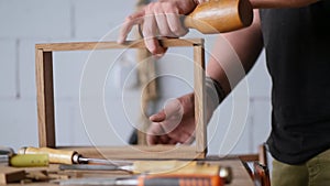 A carpenter assembles a wooden oak box to join it on a dovetail. the sounds of hand carpentry tool