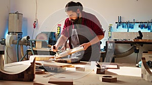 Carpenter in assembly shop starting renovation project on timber plank