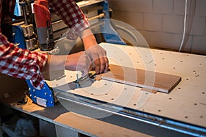 Carpenter attaches board to machine the workpiece surface with CNC,