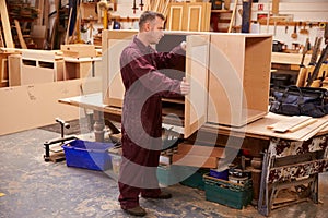 Carpenter Building Furniture In Workshop