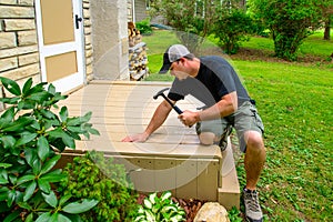 Carpenter Bulding Deck With Hammer photo