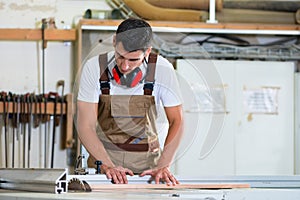 Carpenter or cabinet maker in his wood workshop