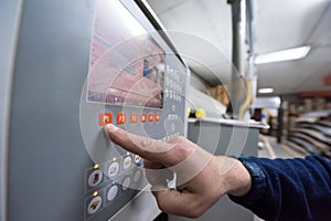 Carpenter calculating and programming a cnc wood working machine