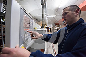 Carpenter calculating and programming a cnc wood working machine