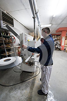 Carpenter calculating and programming a cnc wood working machine