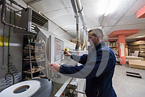 Carpenter calculating and programming a cnc wood working machine