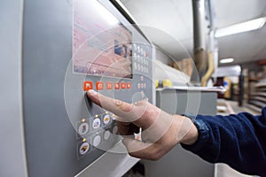 Carpenter calculating and programming a cnc wood working machine