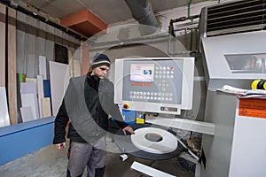 Carpenter calculating and programming a cnc wood working machine