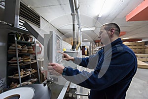 Carpenter calculating and programming a cnc wood working machine
