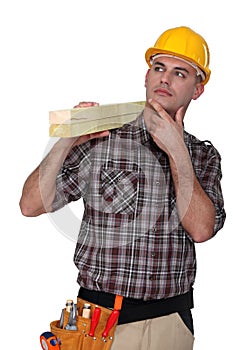 Carpenter carrying lumber