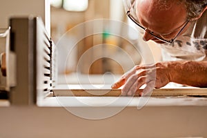 Carpenter checking board on a wood shaper