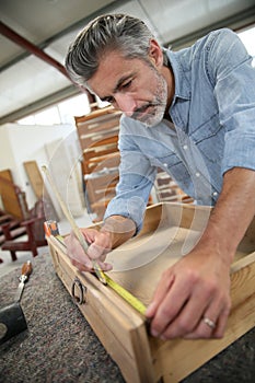 Carpenter creating wood drawer