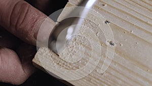 A carpenter cuts out a dovetail on a pine board with a hand jigsaw. dovetail joinery is done with a hand tool. woodworker makes an
