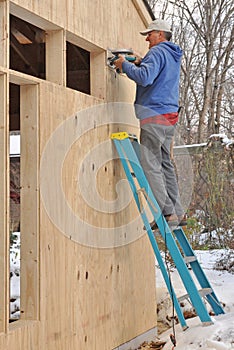 Carpenter cutting openings for windows