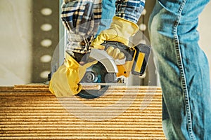 Carpenter Cutting Wood with Circular Saw