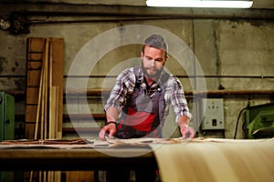 Carpenter doing his job in carpentry workshop