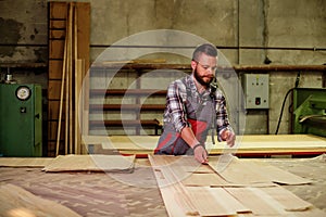 Carpenter doing his job in carpentry workshop