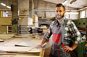 Carpenter doing his job in carpentry workshop