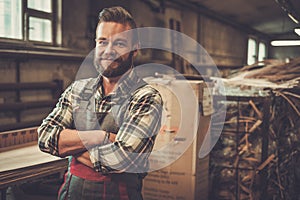 Carpenter doing his work in carpentry workshop.