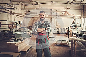 Carpenter doing his work in carpentry workshop. photo