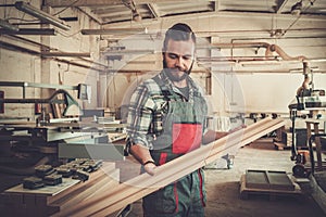 Carpenter doing his work in carpentry workshop.