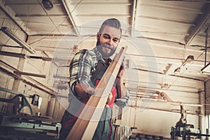 Carpenter doing his work in carpentry workshop.