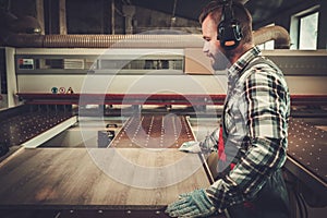 Carpenter doing his work in carpentry workshop.