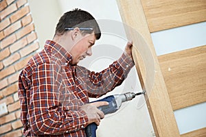 Carpenter at door lock installation