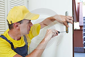 Carpenter at door lock installation