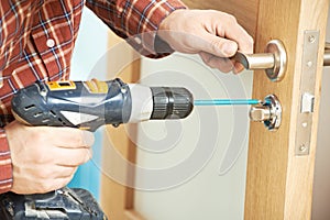 Carpenter at door lock installation