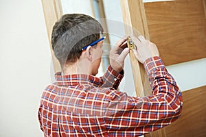 Carpenter at door lock installation