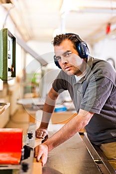 Carpenter with electric cutter photo