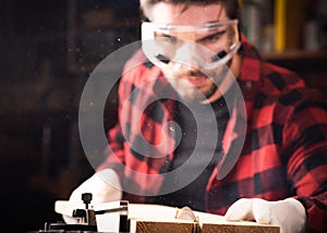 Carpenter engaged in processing wood at the sawmill