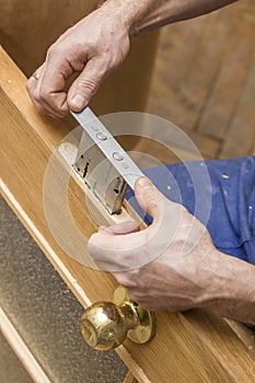 Carpenter establishes the in a wooden door mortise lock.