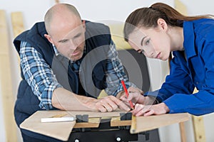 carpenter with female apprentice in training period