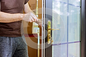 Carpenter fixing lock in door with home
