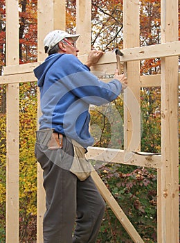 Carpenter framing exterior wall of house