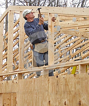 Carpenter framing gable end of house