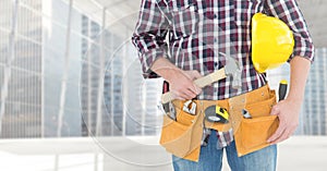 Carpenter with hammer against window